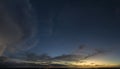 Dramatic sunset sky covered with colorful yellow clouds. Panoramic skyscape