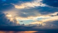 Dramatic sunset sky with dark blue and grey storm clouds illuminated by golden and orange light breaking through Royalty Free Stock Photo