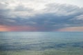 Awe-Inspiring Sunset: Dramatic Sky with Dark Clouds Paints a Beautiful and Colorful Canvas Over the Sea.