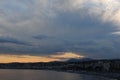 Dramatic sunset sky at dusk over Mediterranean sea at city of Nice, France, French Riviera in summer Royalty Free Stock Photo