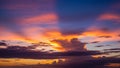 Dramatic sunset sky with vibrant orange and pink clouds illuminated by crepuscular rays against a deep blue sky Royalty Free Stock Photo