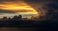 Dramatic Sunset Sky with Intense Golden Light Breaking Through Dark Storm Clouds dark clouds Royalty Free Stock Photo