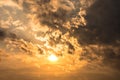 Dramatic sunset sky with orange colored clouds and sun. Royalty Free Stock Photo