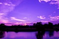 Dramatic sunset in sky and reflect river beautiful colorful tone blue- purple landscape silhouette tree woodland twilight time wit Royalty Free Stock Photo