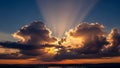Dramatic Sunset Sky with Sun Rays Bursting Through Dark Cumulus Clouds Royalty Free Stock Photo