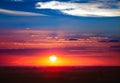 Dramatic sunset sky with sun and spindrift clouds