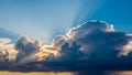 Dramatic sunset sky with towering cumulonimbus clouds and crepuscular rays piercing through the blue Keywords: sky Royalty Free Stock Photo