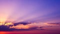 Dramatic sunset sky with vibrant purple and orange hues and sun rays breaking through clouds Royalty Free Stock Photo