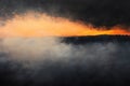 Dramatic sunset with smoky, hazy cloudscape . Royalty Free Stock Photo
