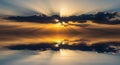 Dramatic Sunset with Sun Rays Breaking Through Clouds Reflected on Calm Water sunrise crepuscular rays Royalty Free Stock Photo