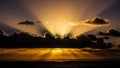 Dramatic Sunset With Sun Rays Breaking Through Dark Clouds Over Ocean crepuscular rays Royalty Free Stock Photo