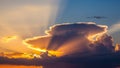 Dramatic sunset with sunbeams radiating from behind a large dark cloud formation rays Royalty Free Stock Photo