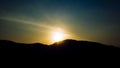 Dramatic sunset or sunrise with sun flare over mountain valley beautiful nature background Royalty Free Stock Photo