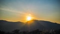 Dramatic sunset or sunrise with sun flare over mountain valley beautiful nature background Royalty Free Stock Photo