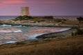 Dramatic Sunset landscape with pink sky and medieval tower, Italy.