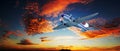 Dramatic sunset with vintage Douglas DC-3 airplane flying under a vibrant cloudy afternoon sky Royalty Free Stock Photo