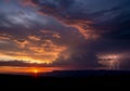 Clouds form intricate patterns, while distant lightning strikes on the Royalty Free Stock Photo