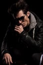 Dramatic thinker in leather jacket and sunglasses Royalty Free Stock Photo