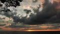 Dramatic thunder clouds at sunset sky