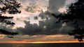 Dramatic thunder clouds at sunset sky