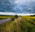 Dramatic thunderstorm cloud over countryside and spring yellow rapeseed fields