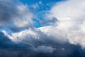 Dramatic thunderstorm clouds floating in blue sky before rain. Majestic cloudscape background