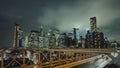 Dramatic thunderstorm clouds over lower Manhattan and night traffic of cars along the Brooklyn Bridge in the foreground Royalty Free Stock Photo