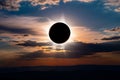 Dramatic Total Solar Eclipse at Sunset: Celestial Event Over Silhouetted Mountains Royalty Free Stock Photo