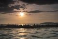 Dramatic tropical evening Sun in Thailand - view over roof top swimming pool in luxury hotel. Dark clouds over palms, sea Royalty Free Stock Photo