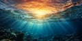 Dramatic underwater seascape with sunbeams piercing through the ocean surface amid rolling waves and a vibrant sunset sky