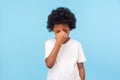 Dramatic unhappy child emotions. Profile of sad little boy with curly hair grimacing and crying Royalty Free Stock Photo