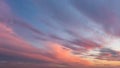 Dramatic vanilla skyscape. Purple orange sunset clouds against blue sky. Scenic dynamic low clouds in a twilight heaven. Weather