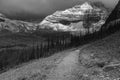 Dramatic view as the early morning sun breaks through the snow heavy clouds of Mt Babel at the back Consolation Lakes, Banff