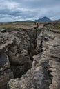 Dramatic view of deep volcanic crustal crack, hiking trail and h Royalty Free Stock Photo