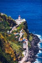 Dramatic view down to lighthouse on Ponta do Arnel, Nordeste, Sao Miguel Island, Azores, Portugal. Lighthouse Arnel near Nordeste Royalty Free Stock Photo