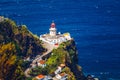 Dramatic view down to lighthouse on Ponta do Arnel, Nordeste, Sao Miguel Island, Azores, Portugal. Lighthouse Arnel near Nordeste Royalty Free Stock Photo