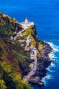 Dramatic view down to lighthouse on Ponta do Arnel, Nordeste, Sao Miguel Island, Azores, Portugal. Lighthouse Arnel near Nordeste Royalty Free Stock Photo