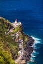 Dramatic view down to lighthouse on Ponta do Arnel, Nordeste, Sao Miguel Island, Azores, Portugal. Lighthouse Arnel near Nordeste Royalty Free Stock Photo