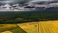 Dramatic view of an incoming storm over a vast expanse of plains, with dark clouds rolling