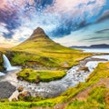 Dramatic view on Kirkjufellsfoss waterfall  near Kirkjufell mountain at sunset Royalty Free Stock Photo