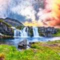 Dramatic view on Kirkjufellsfoss waterfall  near Kirkjufell mountain at sunset Royalty Free Stock Photo