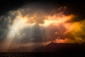 Dramatic view of nature. Black stormy sky over sea and mountains with sun rays through clouds. Salerno, Italy Royalty Free Stock Photo