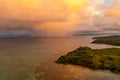 Dramatic view of rain clouds over the ocean. Black and yellow clouds with rain. Sunset. Island Fiji Royalty Free Stock Photo