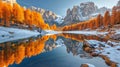 Dramatic view of reflection lake with golden larch trees in mountains