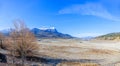 A dramatic view of the Serre-PonÃÂ§on lake totaly dried up with snowy majestic mountains in the background under a majestic blue