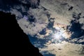 Dramatic view of silhouette mountainside against sundog sky Royalty Free Stock Photo
