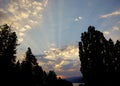 A dramatic view of a sunset in summer, light streaks across the sky