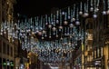Dramatic view of the traditional Christmas decoration lights hanging above Oxford street