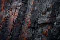 Dramatic volcanic rock formation with fiery orange cracks Royalty Free Stock Photo
