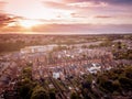 Sun setting with atmospheric effect over traditional British houses and tree lined streets.